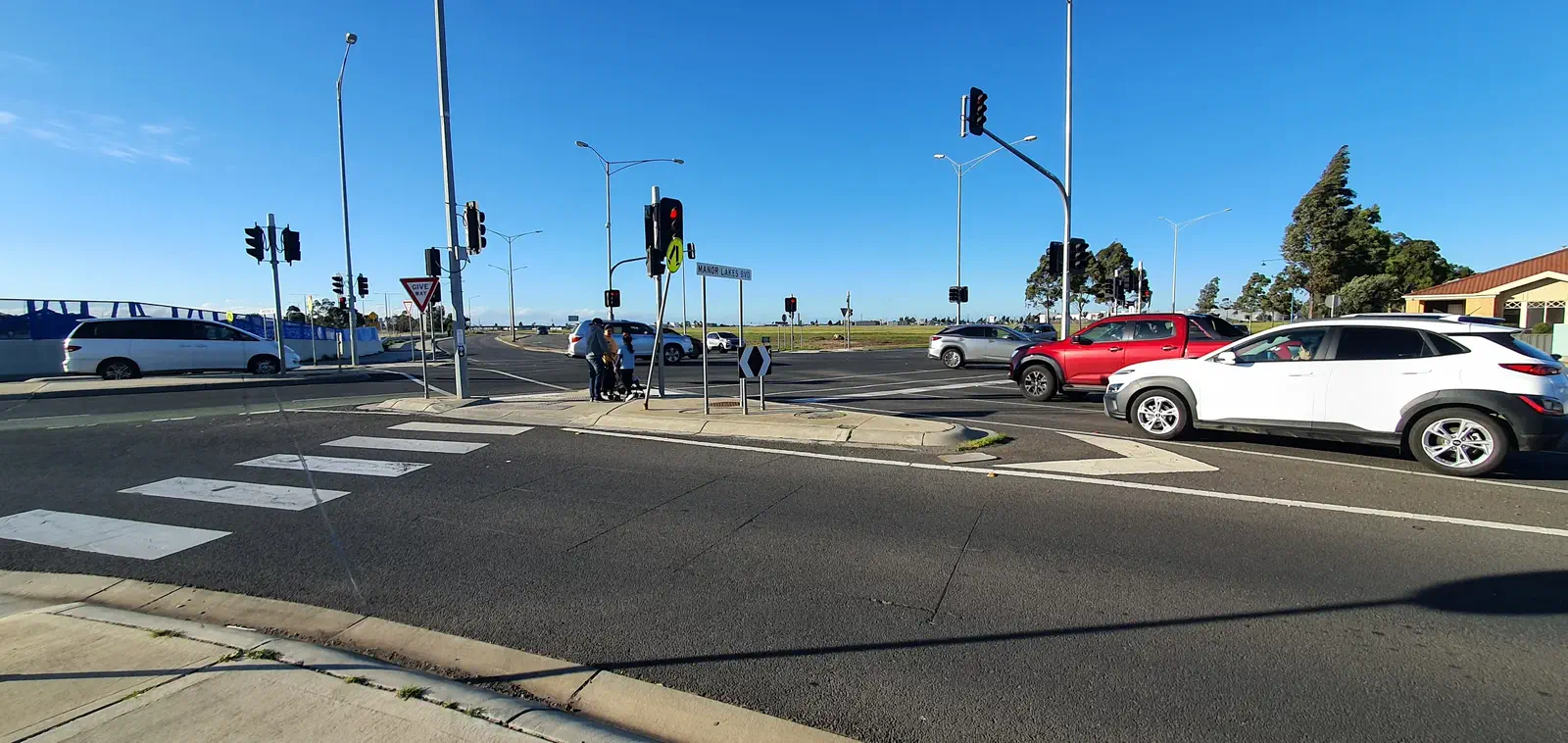 Manor Lakes Boulevard intersection: car-dominated suburban arterial