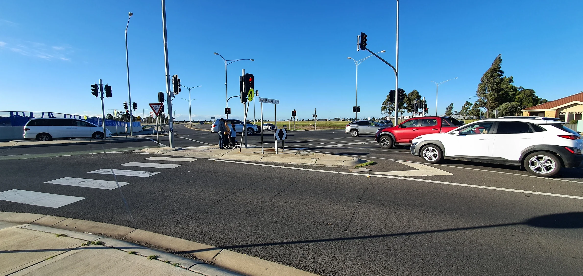 Manor Lakes Boulevard intersection: car-dominated suburban arterial