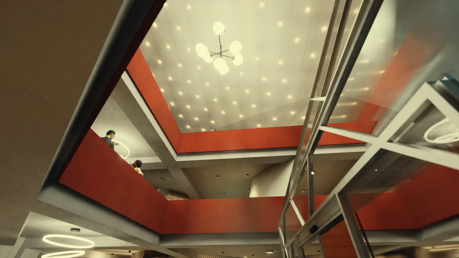Entry atrium: looking up into the faceted shell, the soffit pierced by a field of skylights