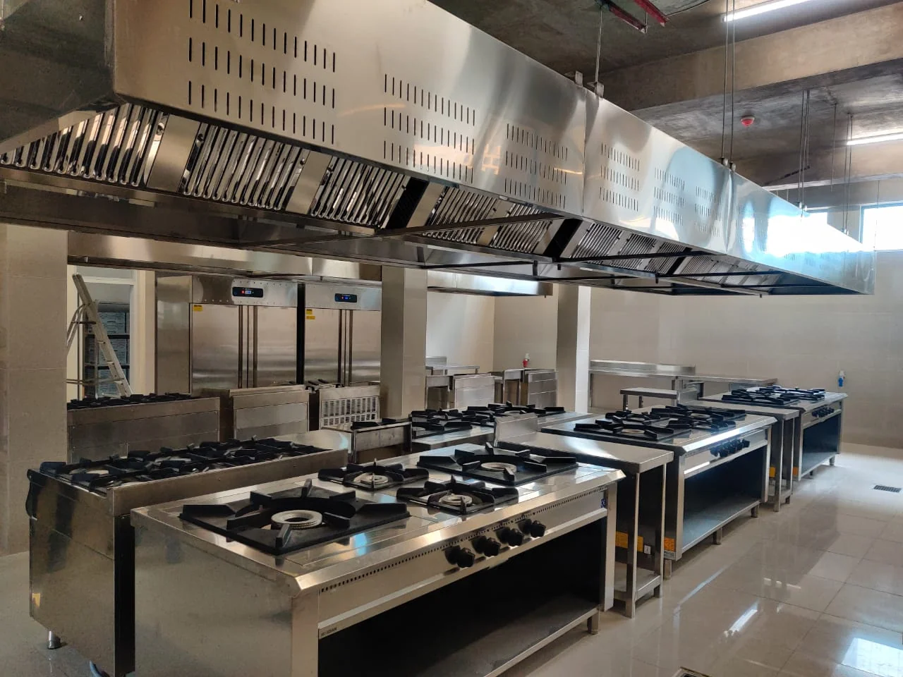 Kitchen as-built: industrial-grade stainless steel cooking line and extraction hood