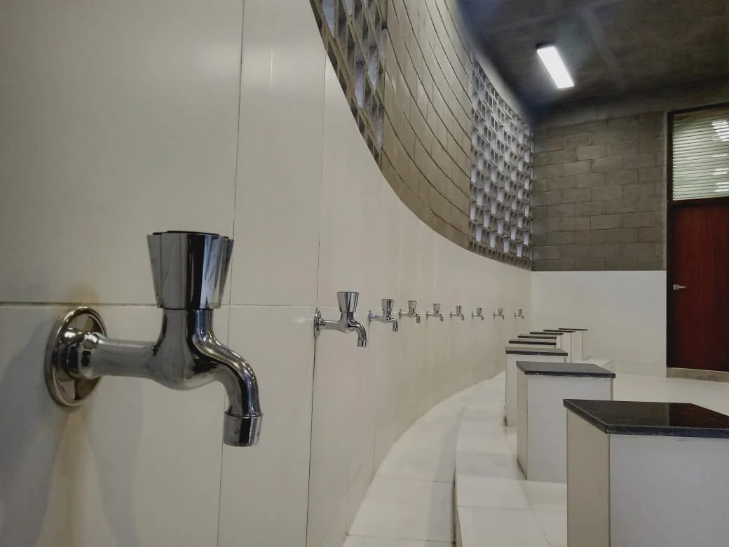 Mosque as-built: ablution area, curved inner wall with row of taps and stone bench
