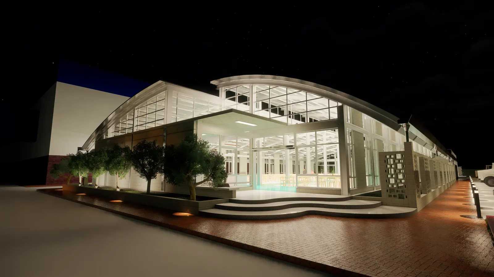 Canteen exterior at night: glazed facade illuminated from within