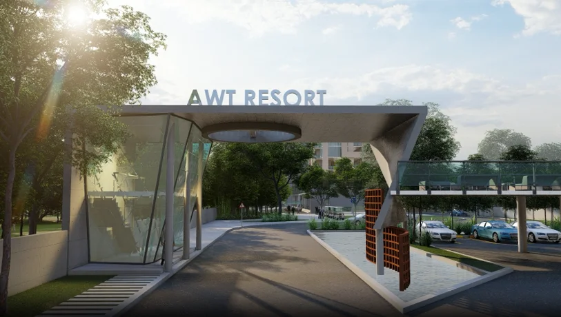 The resort entrance gate: the access control point branded with 'AWT RESORT' signage, a sculptural double-helix marker at the threshold, parking visible beyond the gate