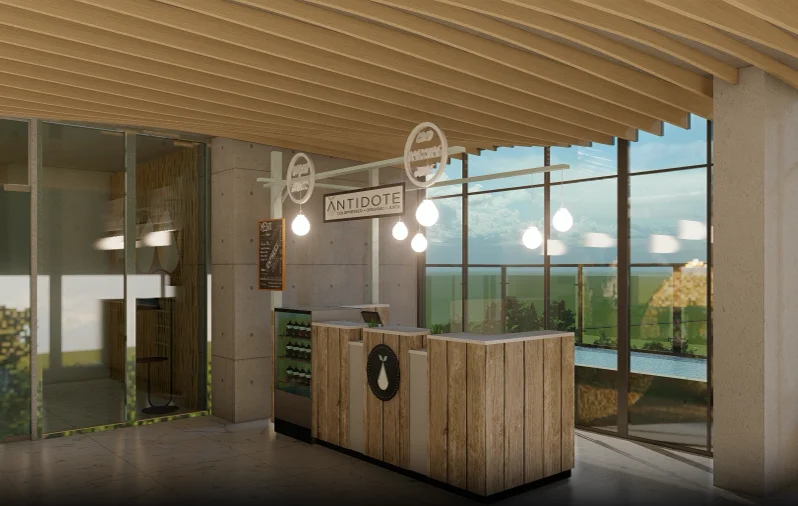 Rooftop juice bar interior: a timber counter with branded signage above, full-height windows along the back wall letting in the sky, terrace seating visible beyond the glazing