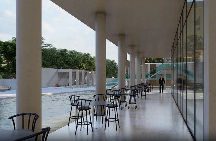 Semi-outdoor café area: a colonnaded arcade with tall white columns, café seating under the overhang, full-height glazing to the interior, the plaza and plantation visible on the open side