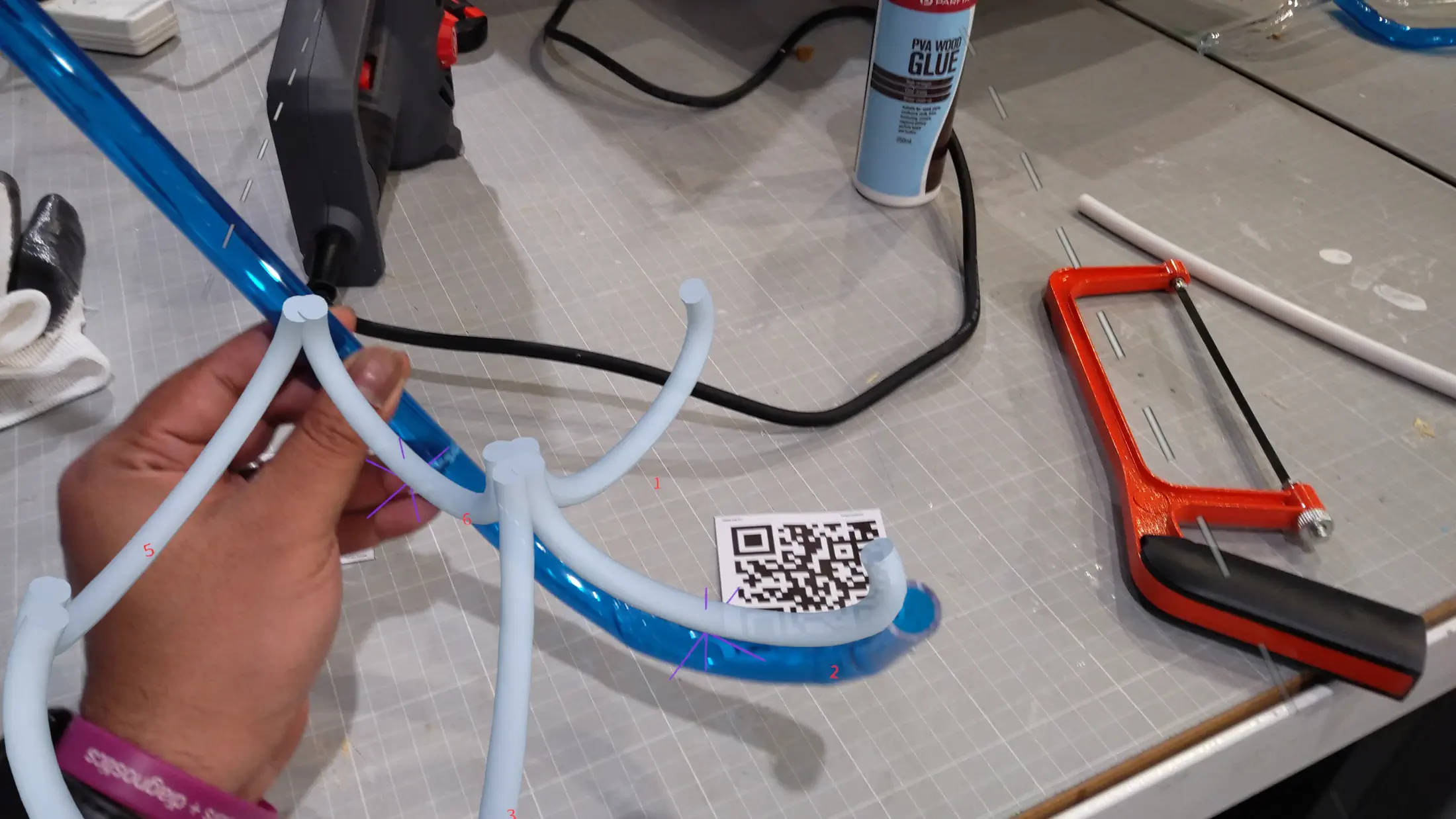 HoloLens capture: close-up of the AR cutting guide, holographic marker aligned to the physical PETG tube surface