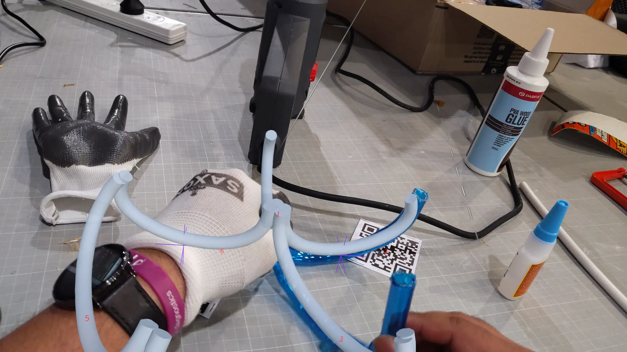 HoloLens capture: upper section of the structure under construction, AR overlay showing remaining tube paths yet to be inserted
