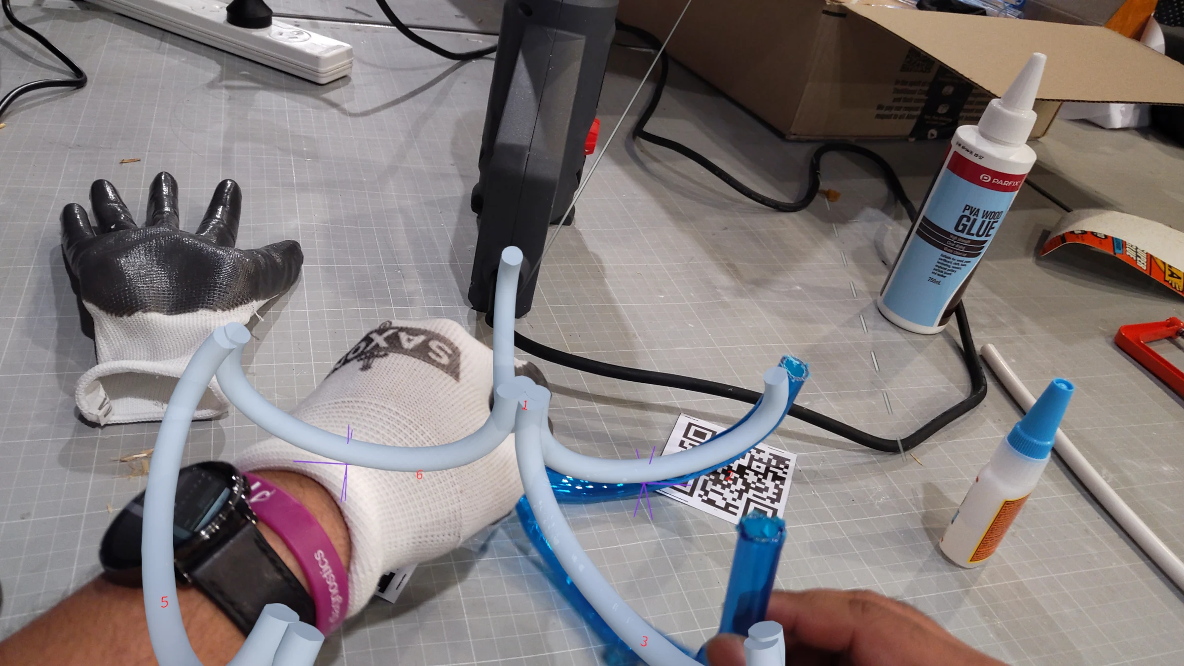 HoloLens capture: upper section of the structure under construction, AR overlay showing remaining tube paths yet to be inserted