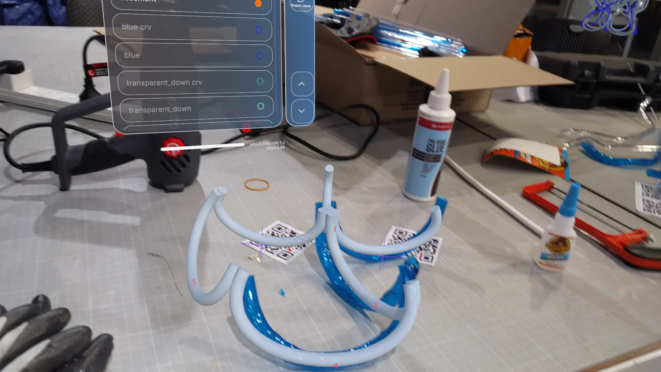HoloLens capture: final assembly phase, last tubes being positioned within the completed lower and mid-section framework